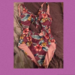 Purple flowered one piece cutout swimsuit.